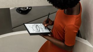 A woman sketches on the Onyx Boox Note Air 2 Plus