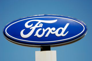The famous Ford logo above a car dealership