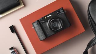 Best cameras for Instagram: Fujifilm X100VI camera in black on an orange box