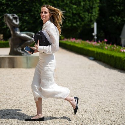a woman wearing a white Linen Skirt and linen shirt