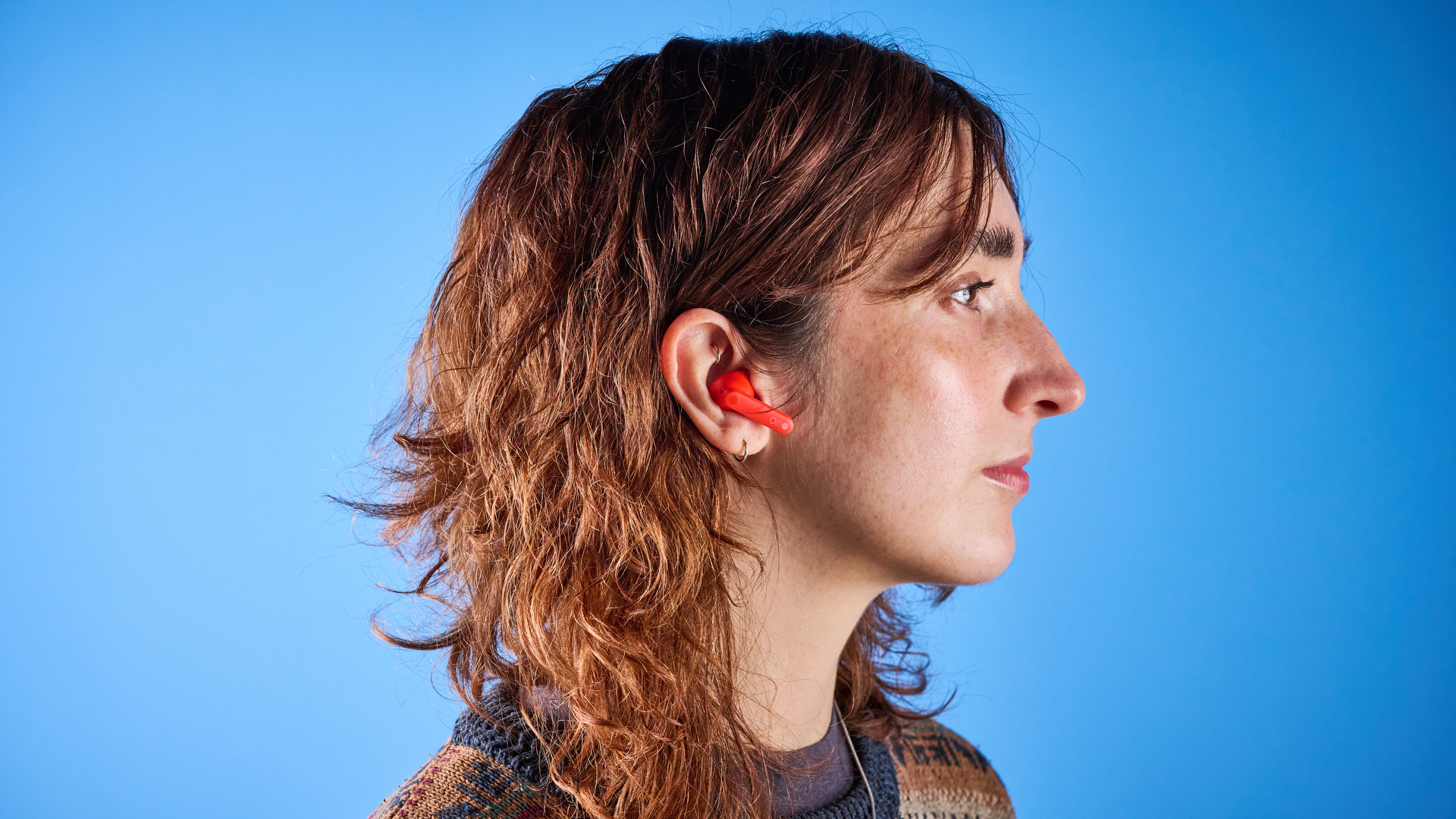 the nothing cmf buds pro 2 cmf by nothing buds pro 2 in bright orange shown in the smart dial charging case against a blue tom&#039;s guide background