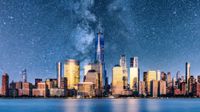 A view of NYC with a composite of a super starry sky behind.