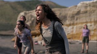 A young woman screaming on a beach in a shot from The Wilds on Prime Video