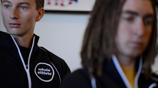 Whole Athlete-Specialized riders sit in a lecture, learning at team camp