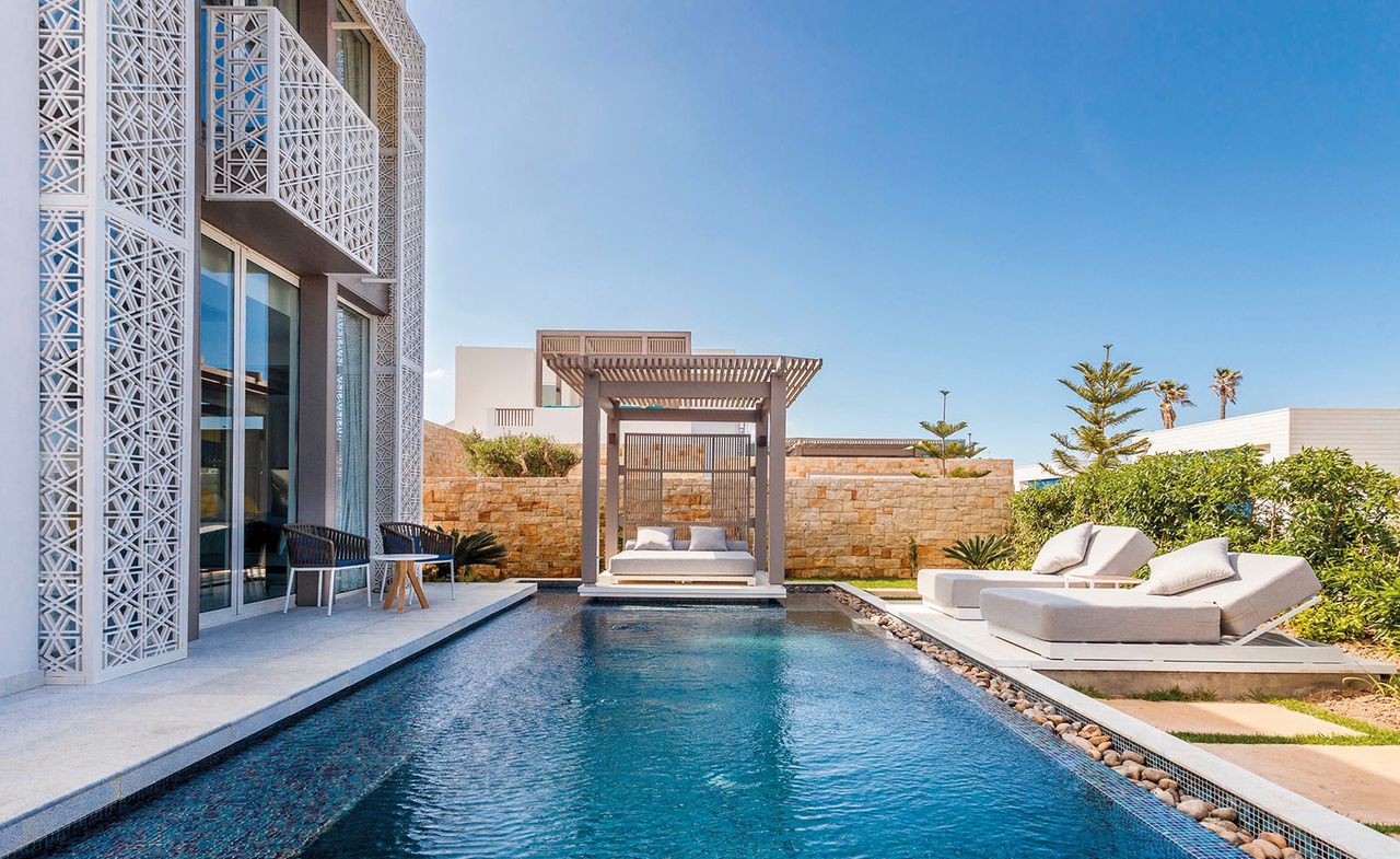 Outdoor pool with sun loungers surrounding