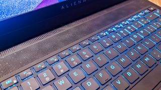 Alienware X14 on a table, playing Hitman III