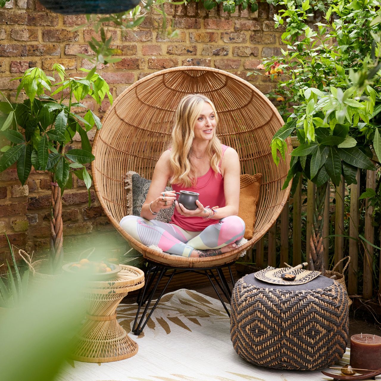 Fearne Cotton sat in a hanging chair in her Yogi garden
