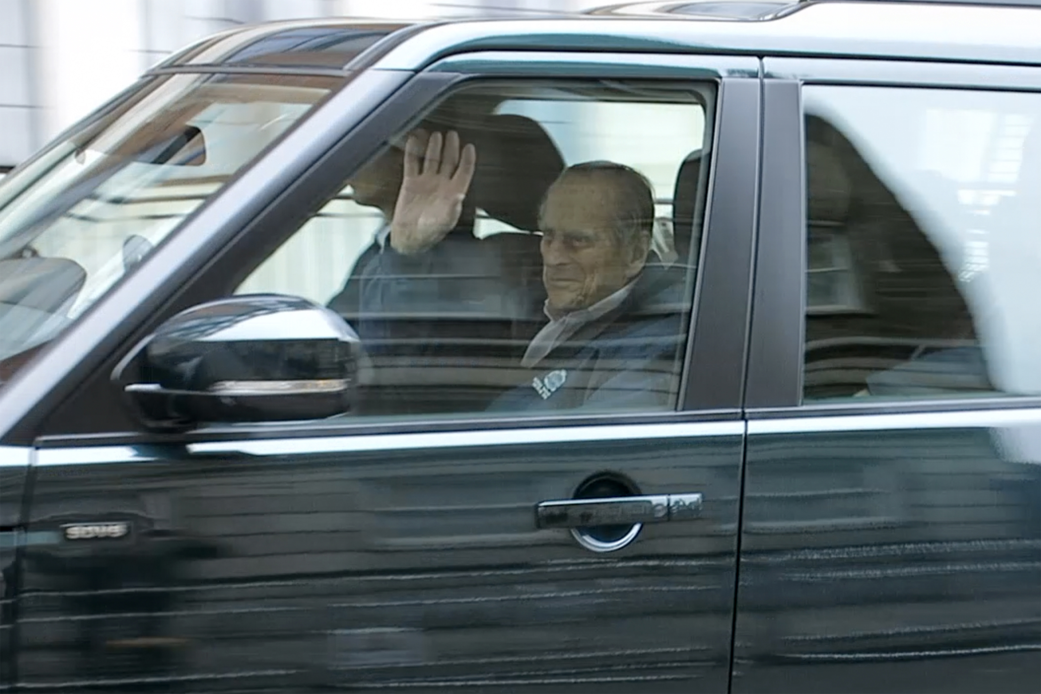 Prince Philip waving from a car