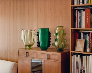 Glass vases on wooden shelf