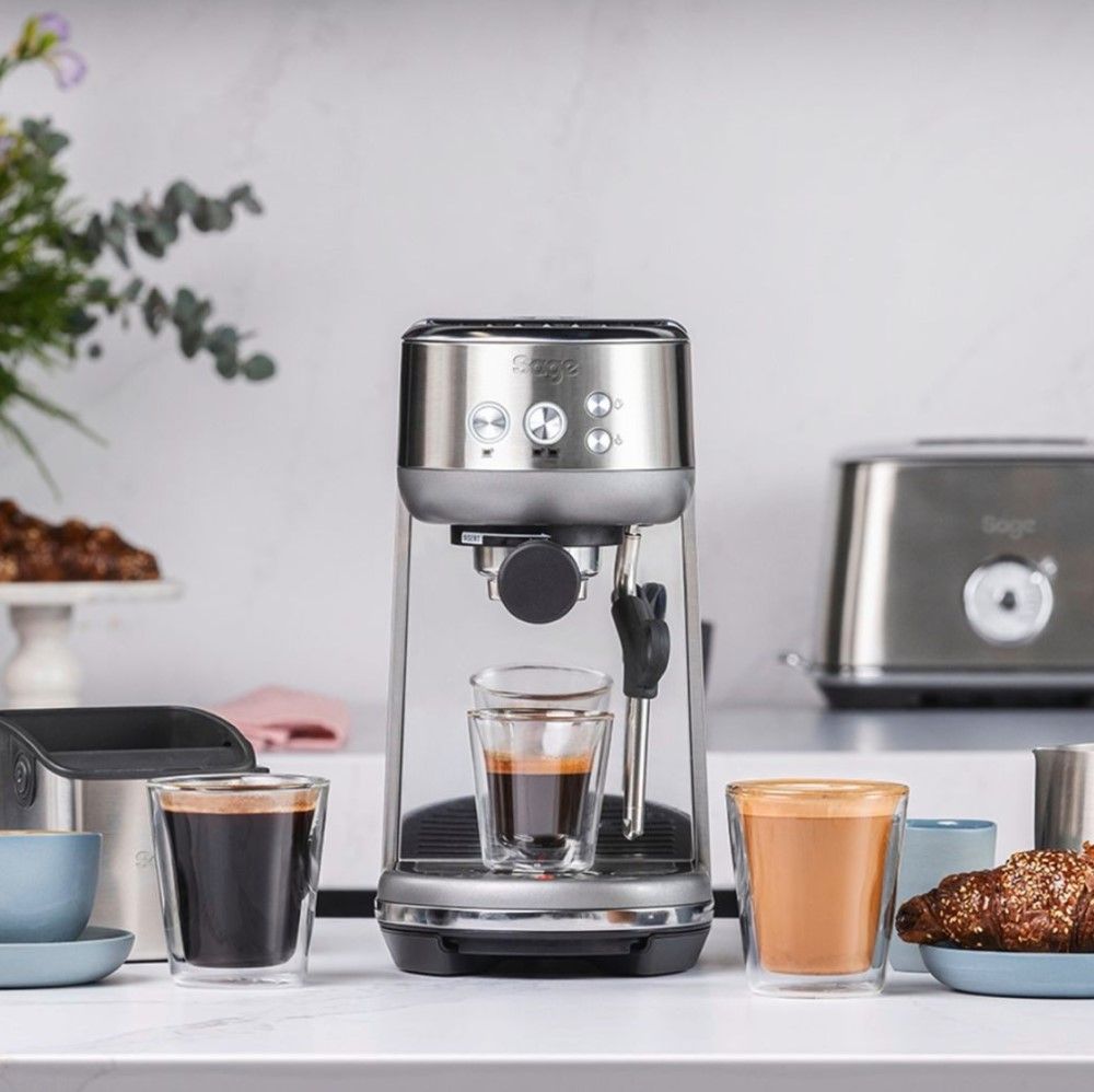 Sage Bambino on kitchen counter surrounded by fresh coffee drinks