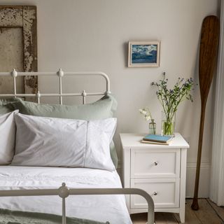 bedroom with bed and photoframe on white wall