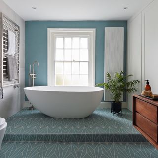 blue and white tiled bathroom with standalone bath