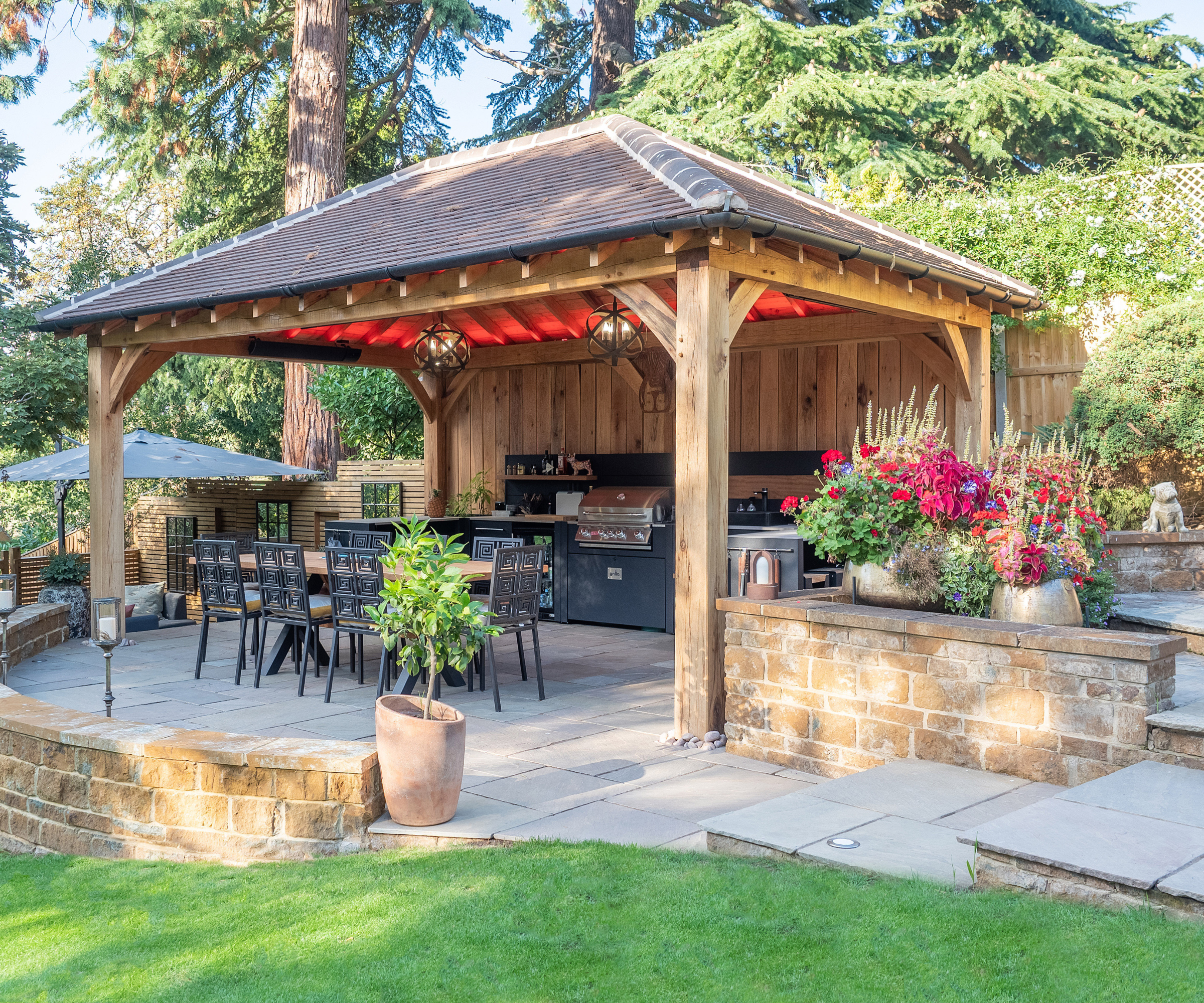 Outdoor kitchen and seating area under the pergola