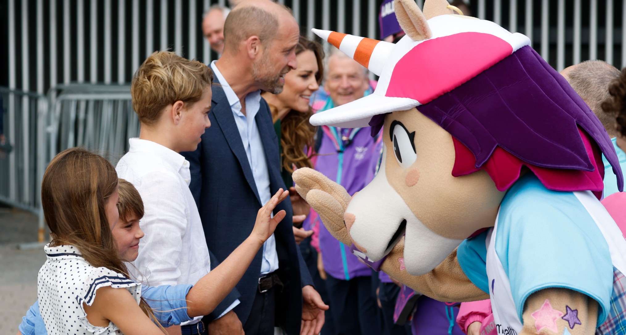 Princess Charlotte and Prince Louis meeting a unicorn mascot next to Prince George , Princess Kate and Prince William