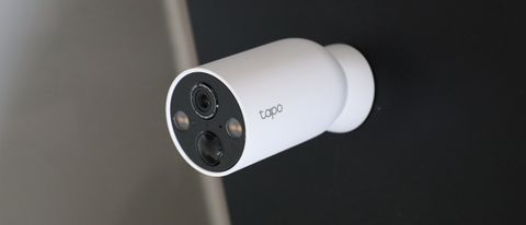 TP-Link Tapo C425 security camera mounted on a black wall