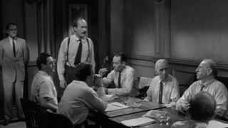Jurors in a courtroom deliberate in 12 Angry Men