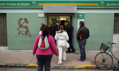 People file into a government job center in Chipiona: Spain has the largest unemployment rate in the eurozone, which is only hurting the country's crippling debt problem.