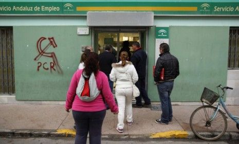 People file into a government job center in Chipiona: Spain has the largest unemployment rate in the eurozone, which is only hurting the country&amp;#039;s crippling debt problem.