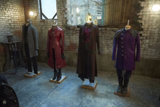 Four colorful costumes hanging