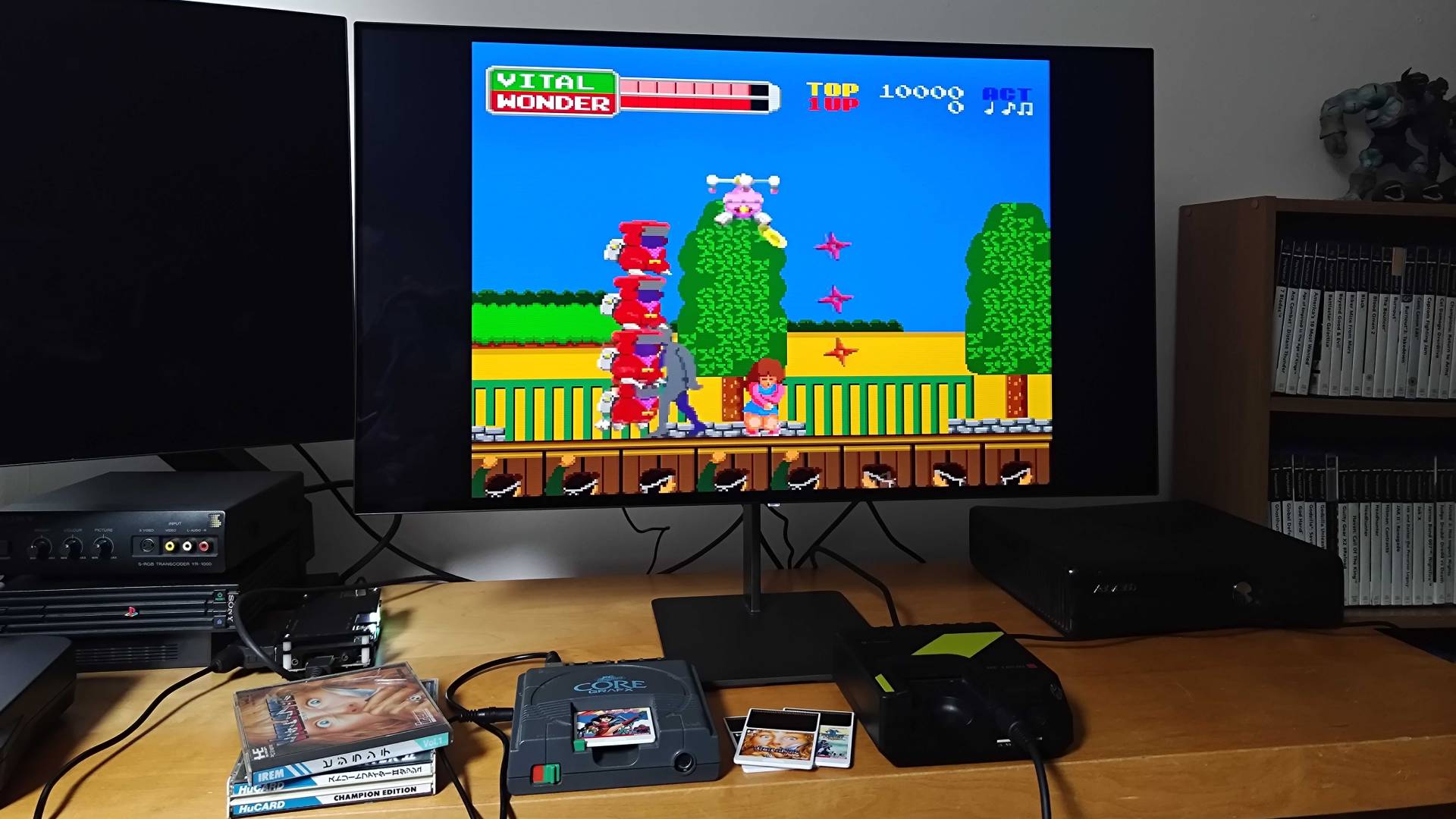 PC Engine running Wonder Momo next to Hyperkin Retron GX beneath monitor.