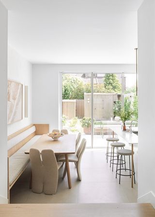 white open plan kitchen and dining room with modern chairs