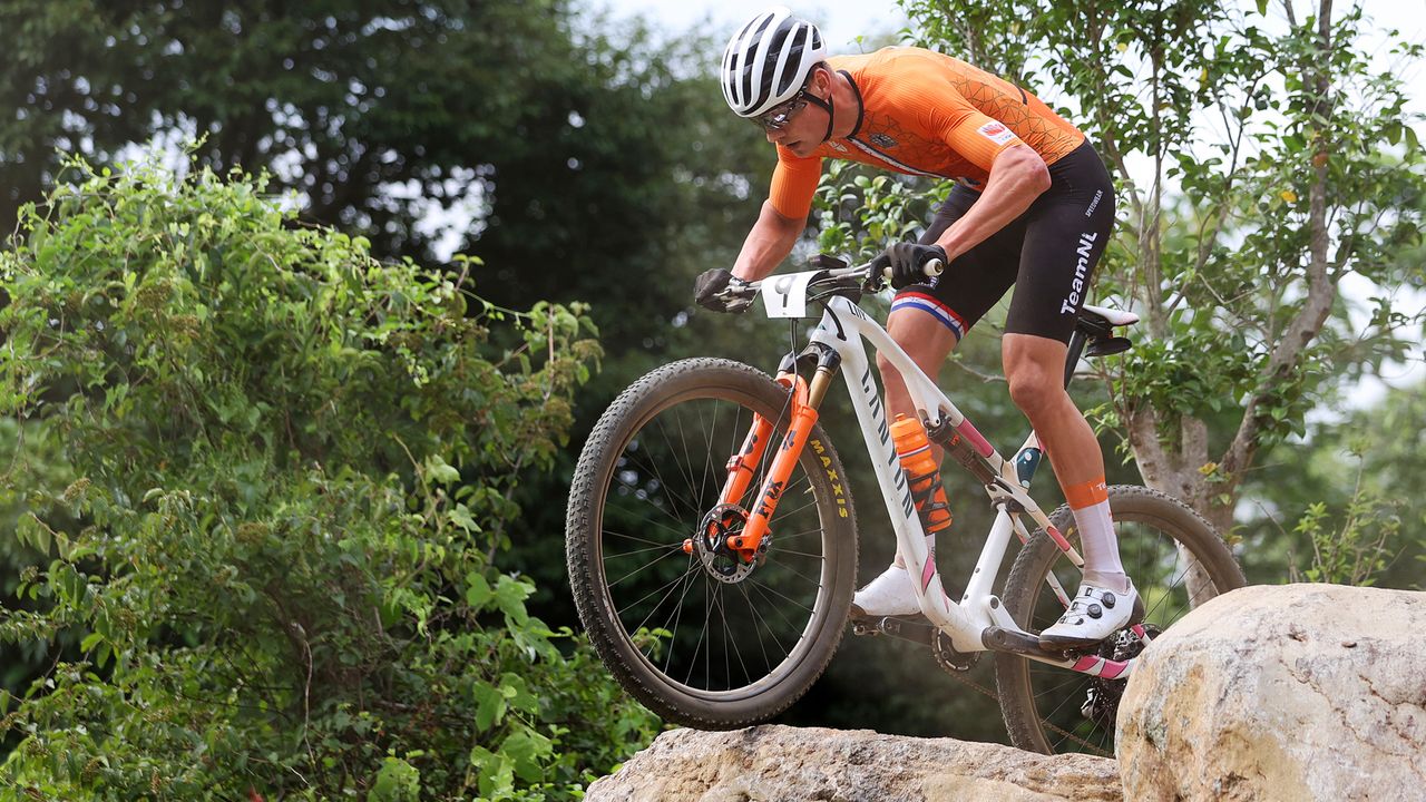 Mathieu van der Poel of Team Netherlands suffers a fall ahead of Thomas Pidcock of Team Great Britain during the Men's Cross-country race on day three of the Tokyo 2020 Olympic Games at Izu Mountain Bike Course