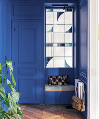 Blue hallway with stained glass panels