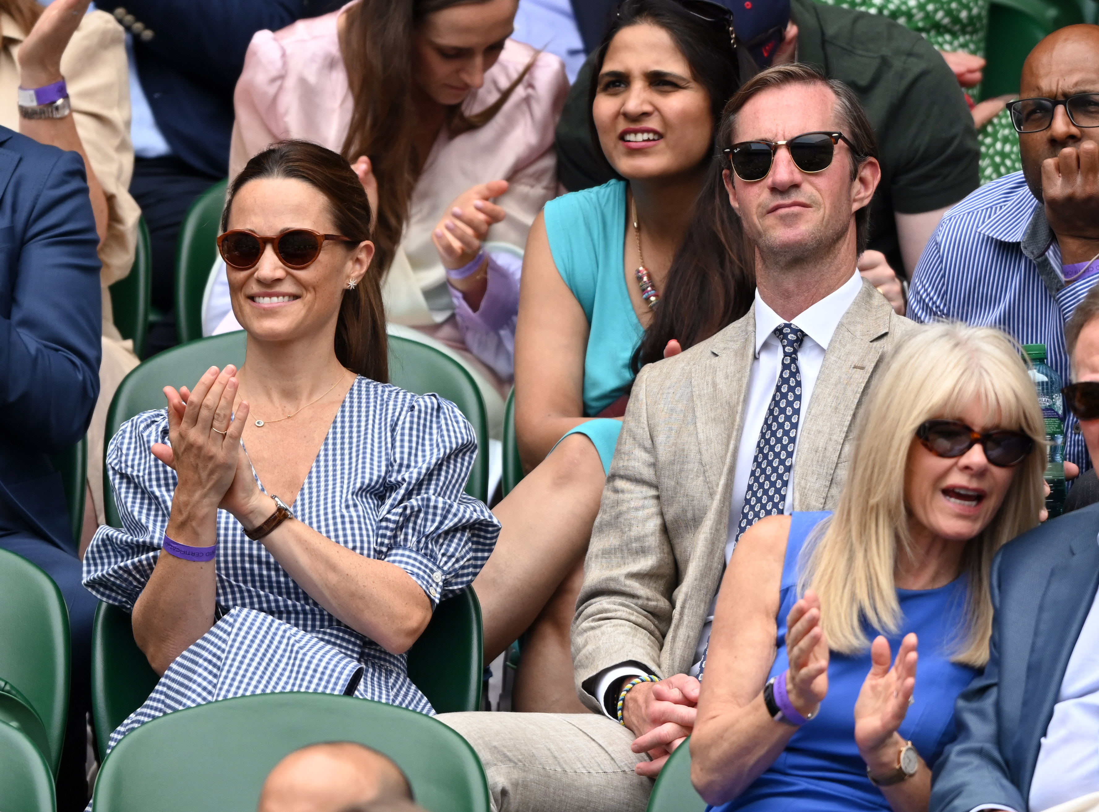 Pippa and James Matthews sitting in the stands at Wimbledon clapping