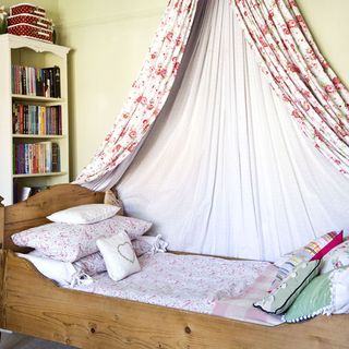 kids bedroom with wooden single bed and canopy