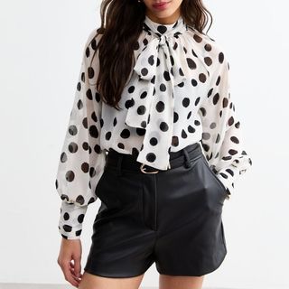 Flat lay image of spotted blouse