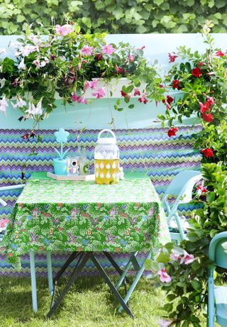 outdoor table with climbing roses surrounding it