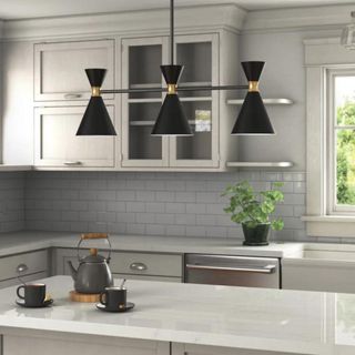 Grey kitchen with three-prong pendant light above island