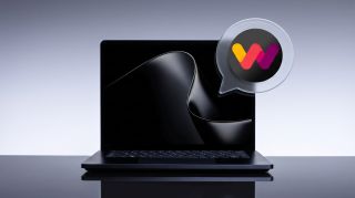 A sleek Surface Laptop UItra with a glossy abstract wave on screen sits against a pale gray backdrop, beside a speech-bubble icon with a colorful W logo.