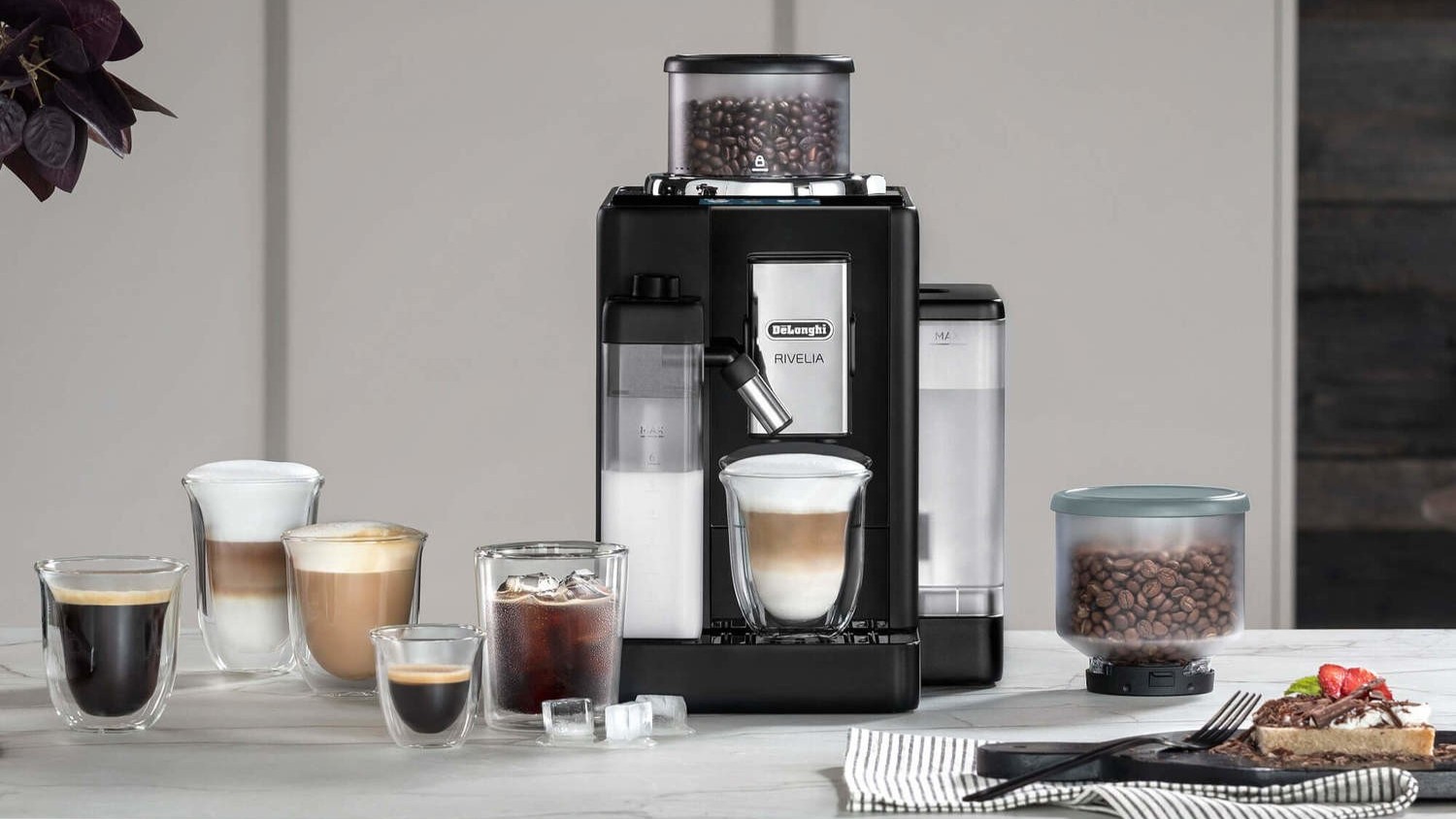 De'Longhi Rivelia coffee machine with various coffee drinks on kitchen counter
