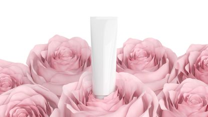 Cosmetic bottle surrounded by pink roses