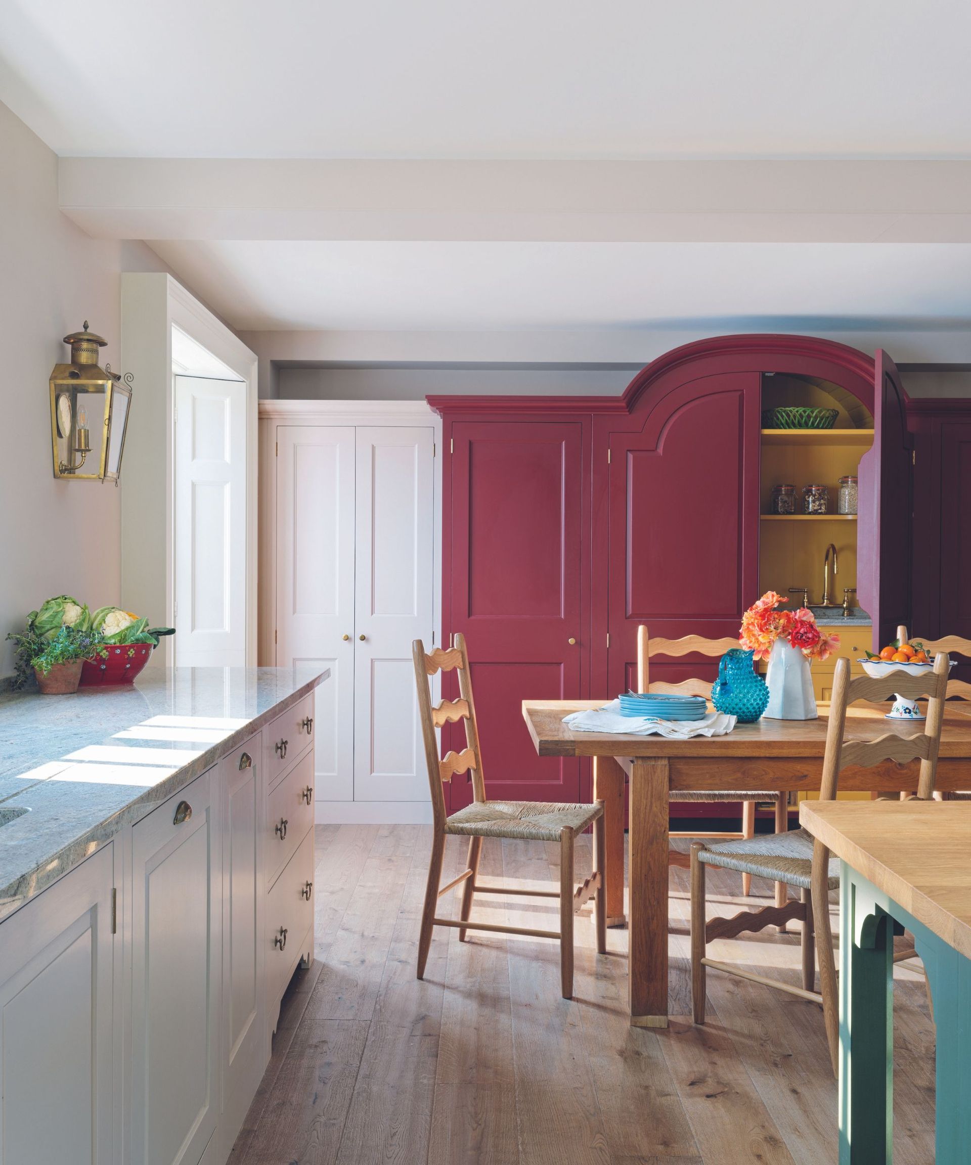 White kitchen with red accent cabinet