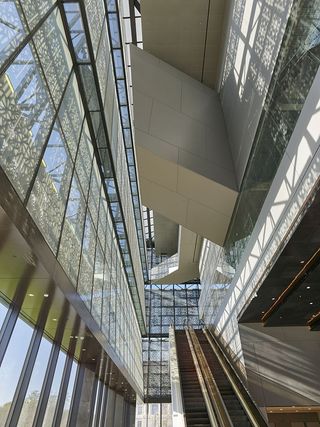 Switchbacking ramps and a twisting black staircase lead up to the building’s main lobby