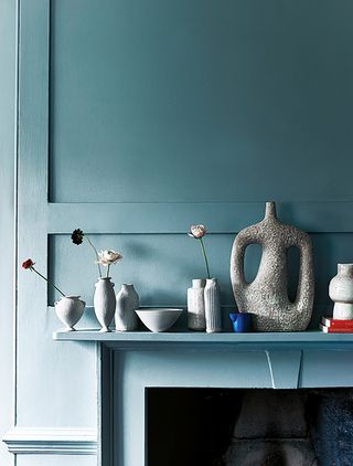 Blue mantelpiece with artisan ceramic vases