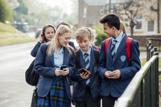 group of secondary school aged pupils walking home from school at Christmas time