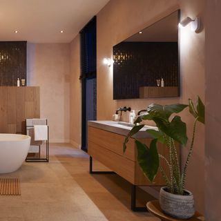 Large bathroom with large washbasin unit, large mirror and two wall-mounted lights.