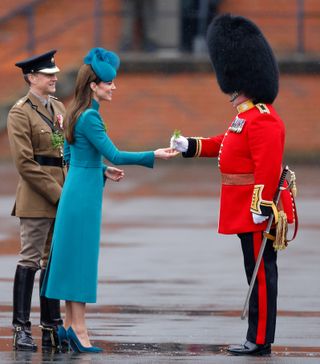 Catherine, Princess of Wales (in her role as Colonel of the Irish Guards) presents traditional sprigs of shamrock to Officers and Guardsmen of the Irish Guards as she attends the 2023 St. Patrick's Day Parade at Mons Barracks on March 17, 2023 in Aldershot, England.