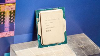 An Intel Core i5-14600K against its promotional packaging