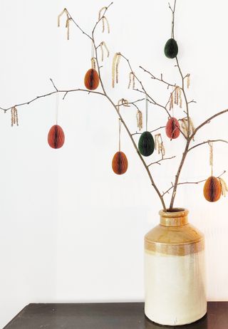 a vase with an easter tree with paper easter egg decorations