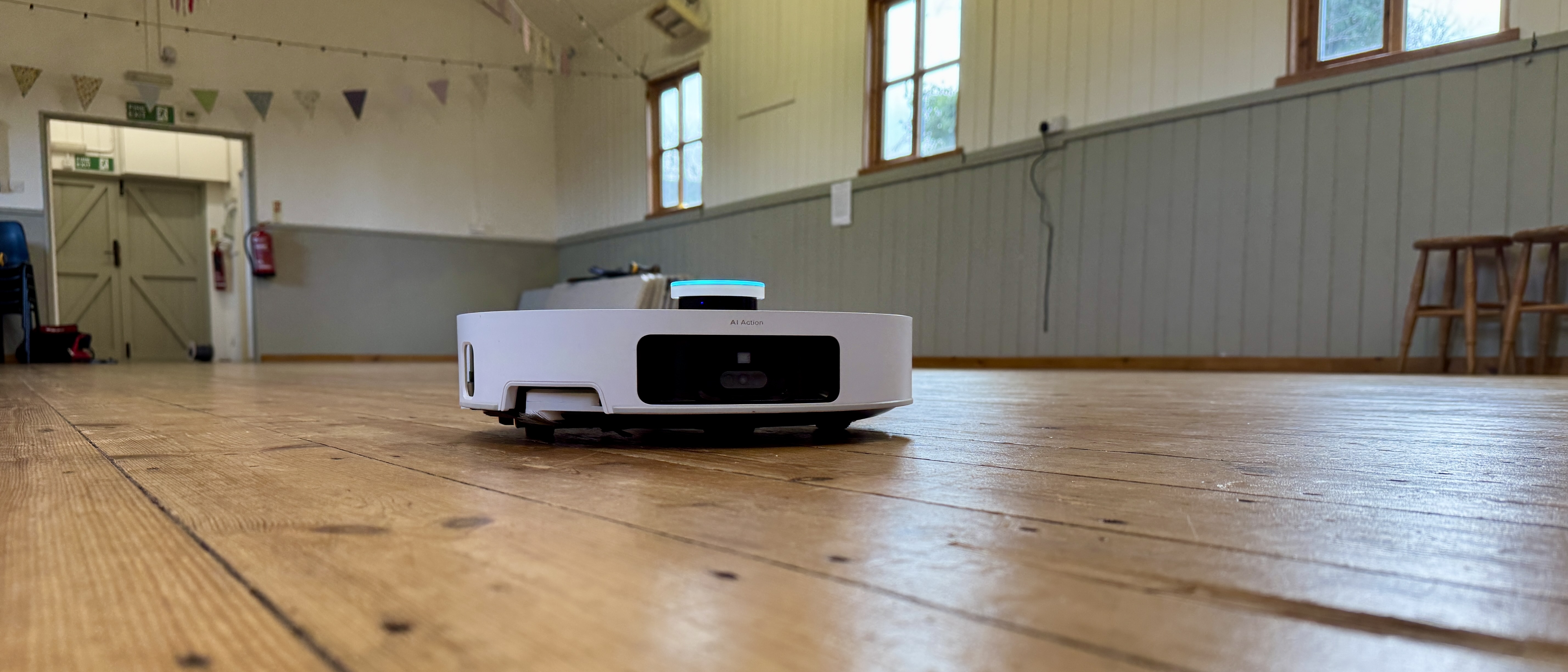 Dreame Matrix10 Ultra robot vacuum on a wooden floor in a large hall