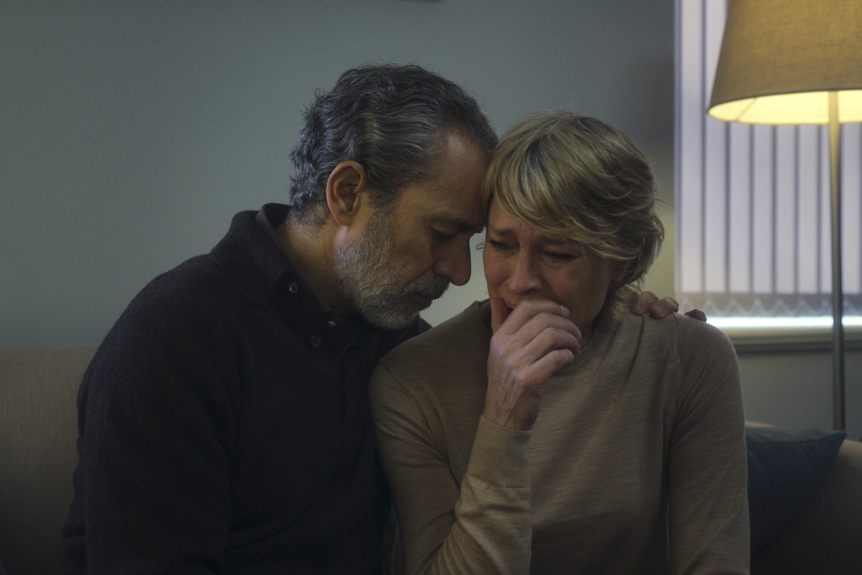 Waleed Zuaiter as howard and robin wright as laura crying and holding each other in the girlfriend
