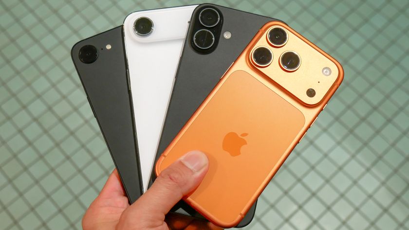 A bunch of iPhones held in the hand.