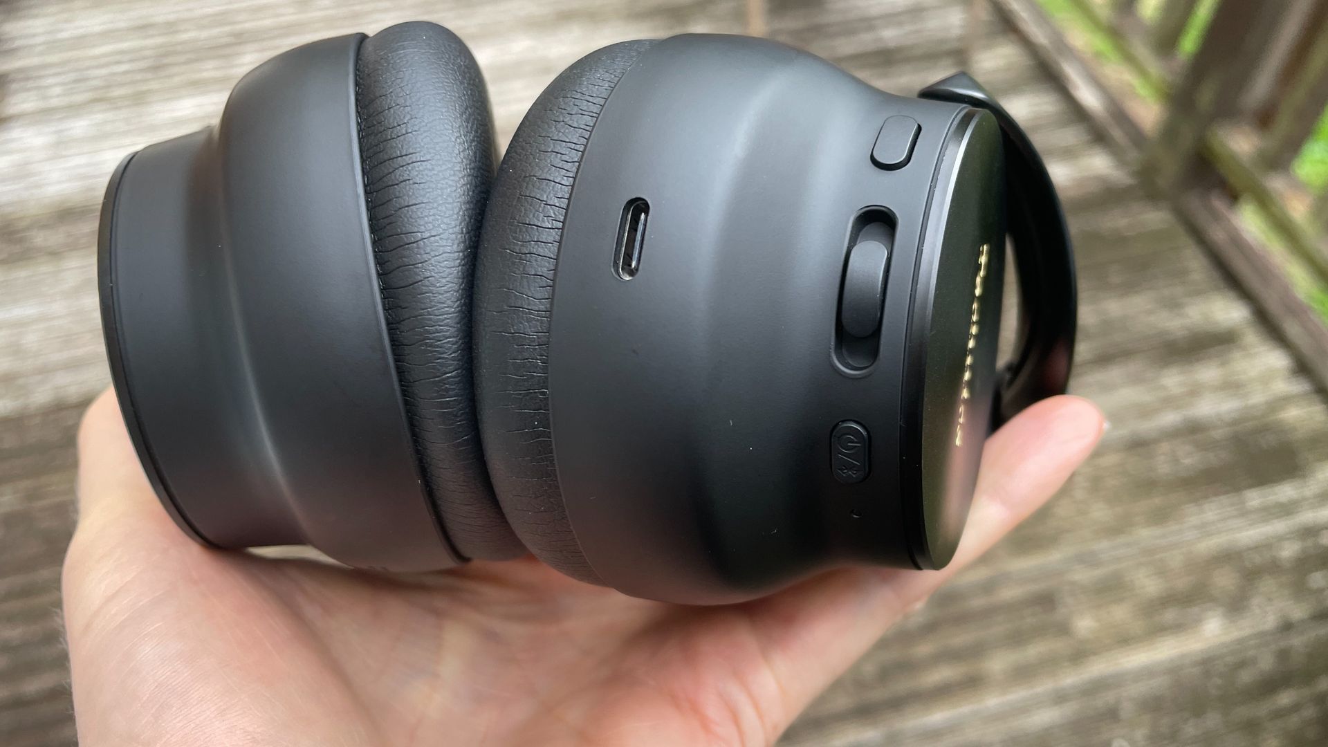 Technics EAH-A1000 headphones in black, in a garden