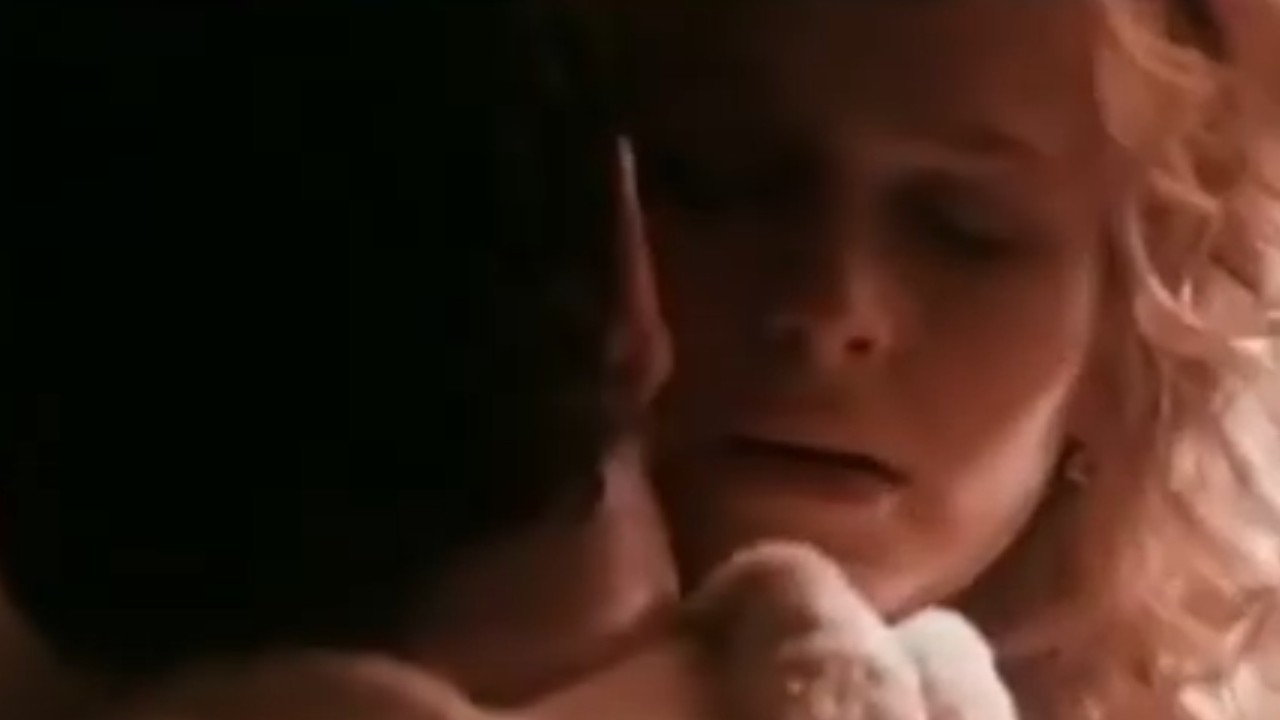 Kyra Sedgwick embracing a man in Phenomenon