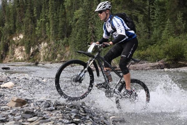 A TransRockies rider makes their way back onto (sort of) dry land