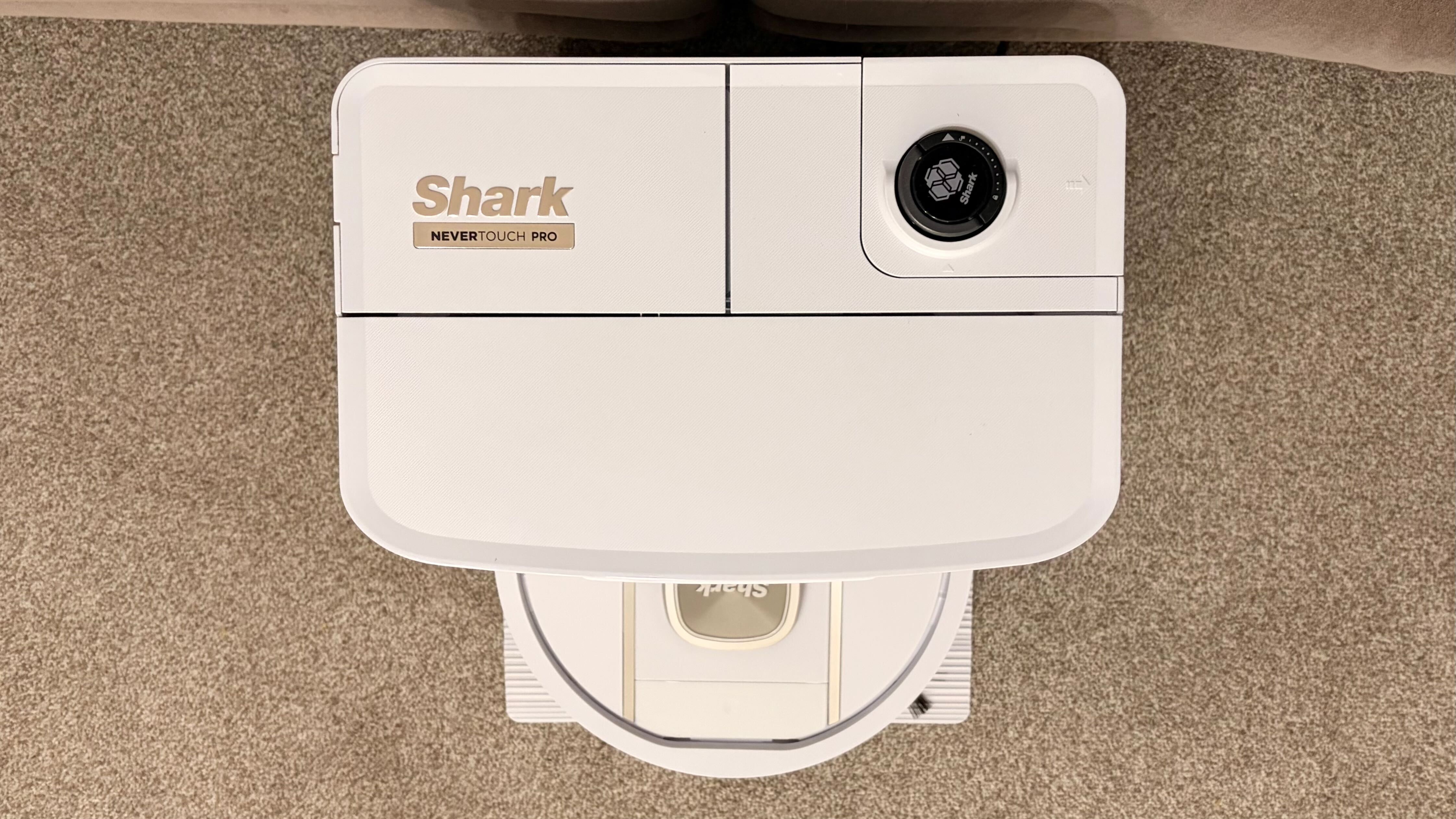 Shark PowerDetect 2-in-1 ThermaCharged NeverTouch photographed on a carpet with docking station